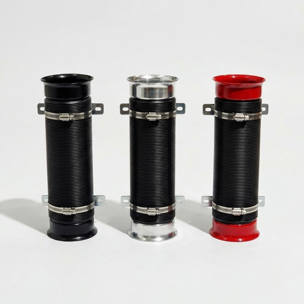 Three corrugated cylindrical pipe couplers with metal clamp bands, shown on a light gray studio background. The left and center pieces are black with silver metal bands and silver end caps, and the right piece is black with a red top and red bottom.