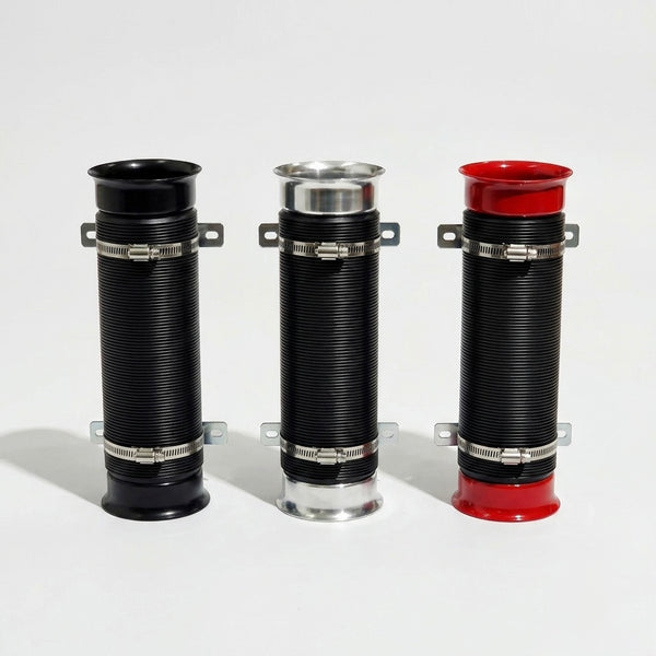 Three corrugated cylindrical pipe couplers with metal clamp bands, shown on a light gray studio background. The left and center pieces are black with silver metal bands and silver end caps, and the right piece is black with a red top and red bottom.